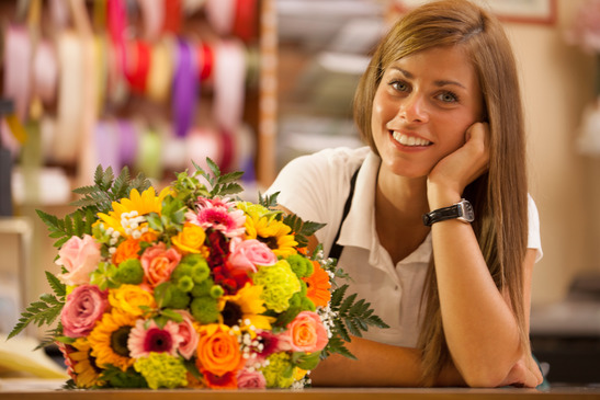 Beautiful smiling florist with colorful bouquet